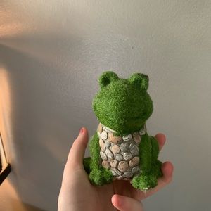 Green moss and rock frog statue